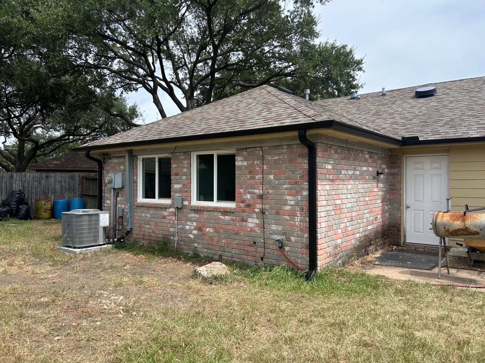 Brick home with roof and white-frame windows