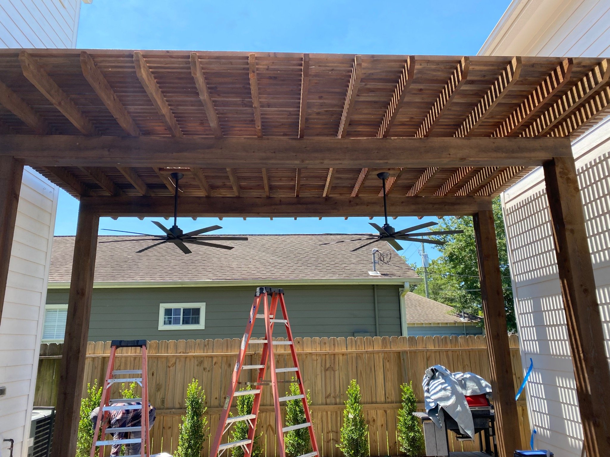 Wooden pergola built over a backyard patio