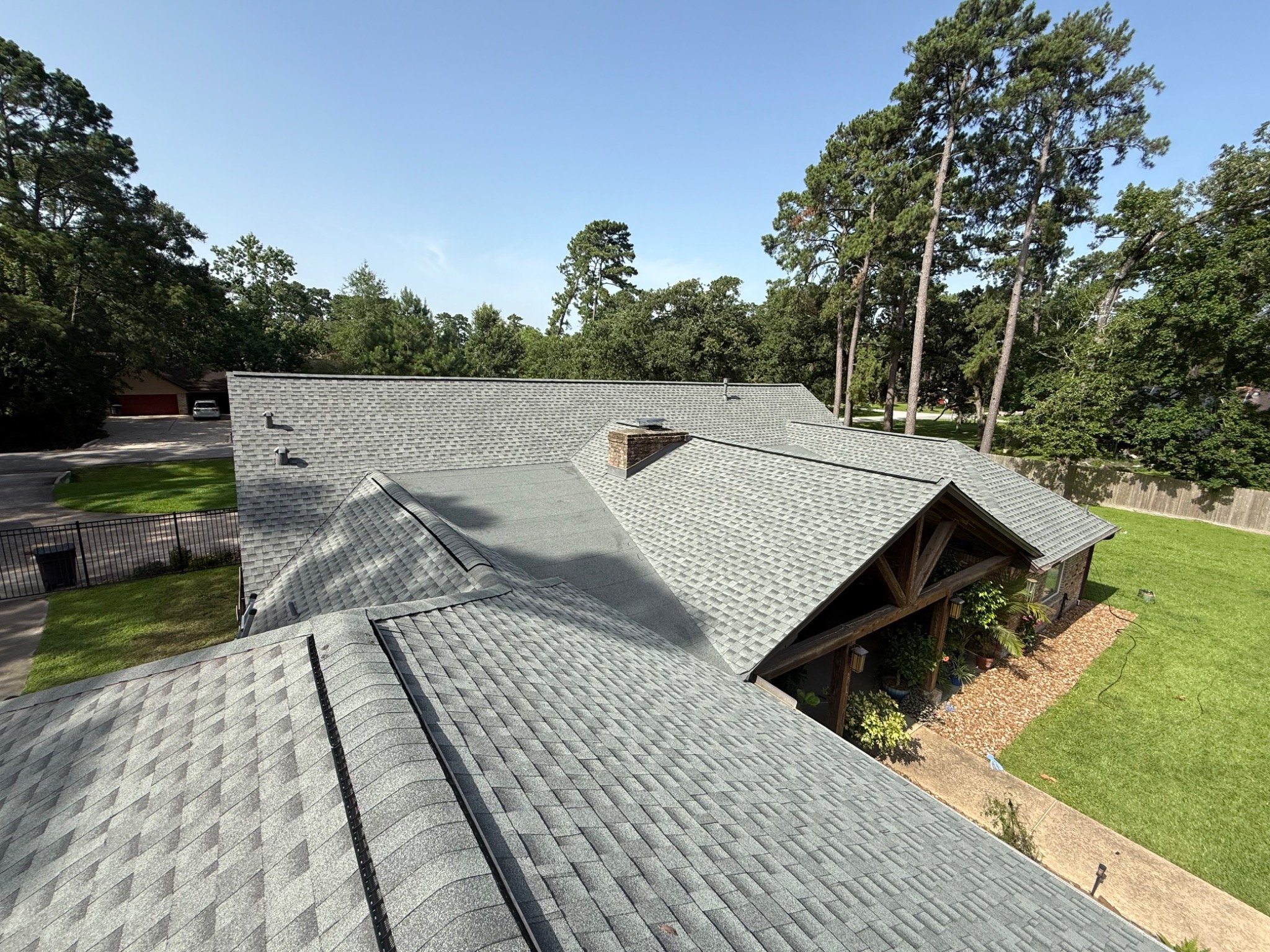 Wide view of a completed gray shingle roof